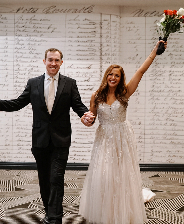 a man and woman holding hands and smiling