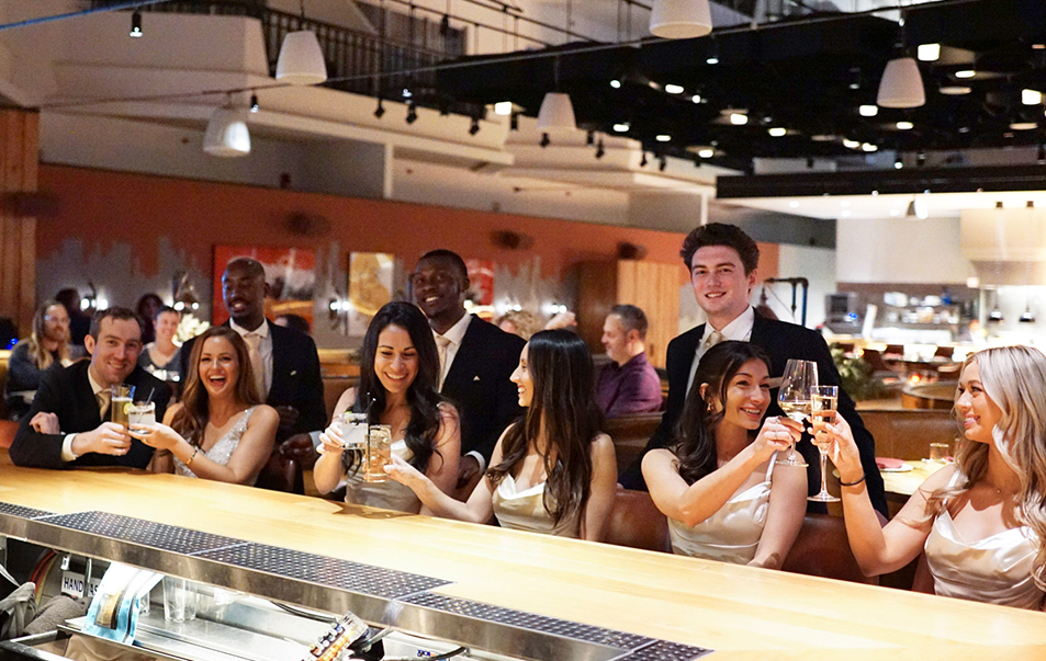 a group of people sitting at a bar