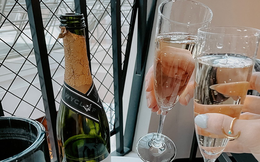 a hand holding a glass of champagne