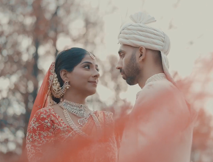 a man and woman in traditional attire looking at each other