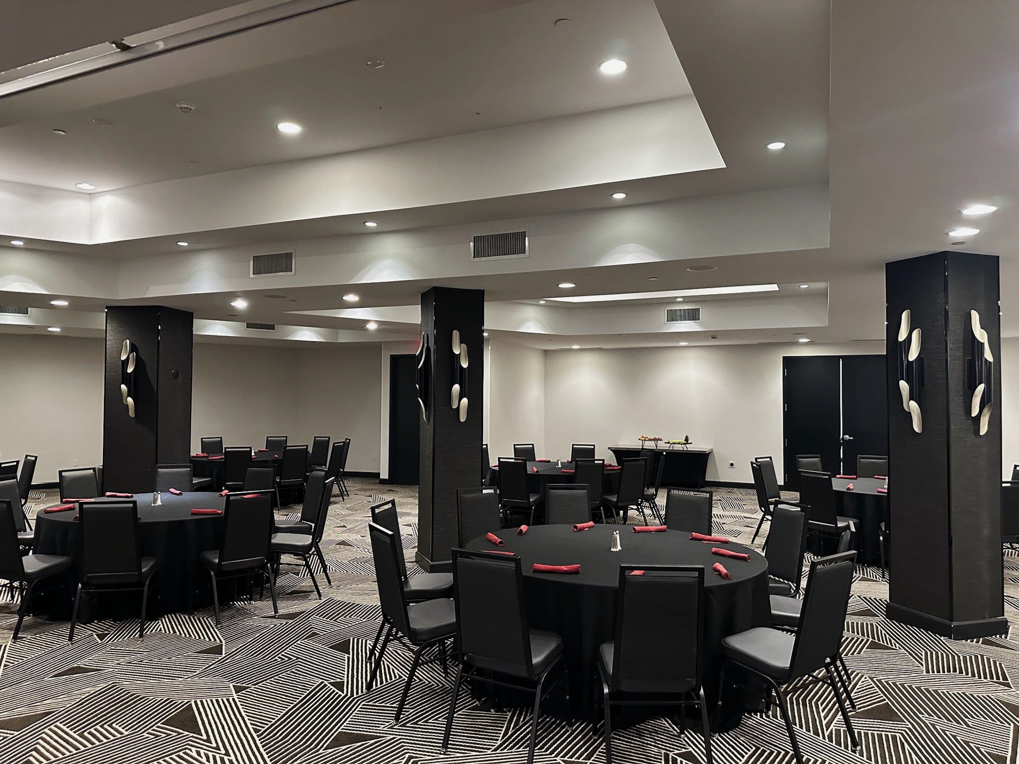 a room with black chairs and tables