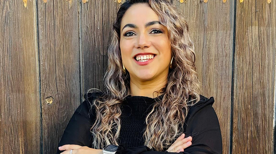 a woman with long blonde hair smiling