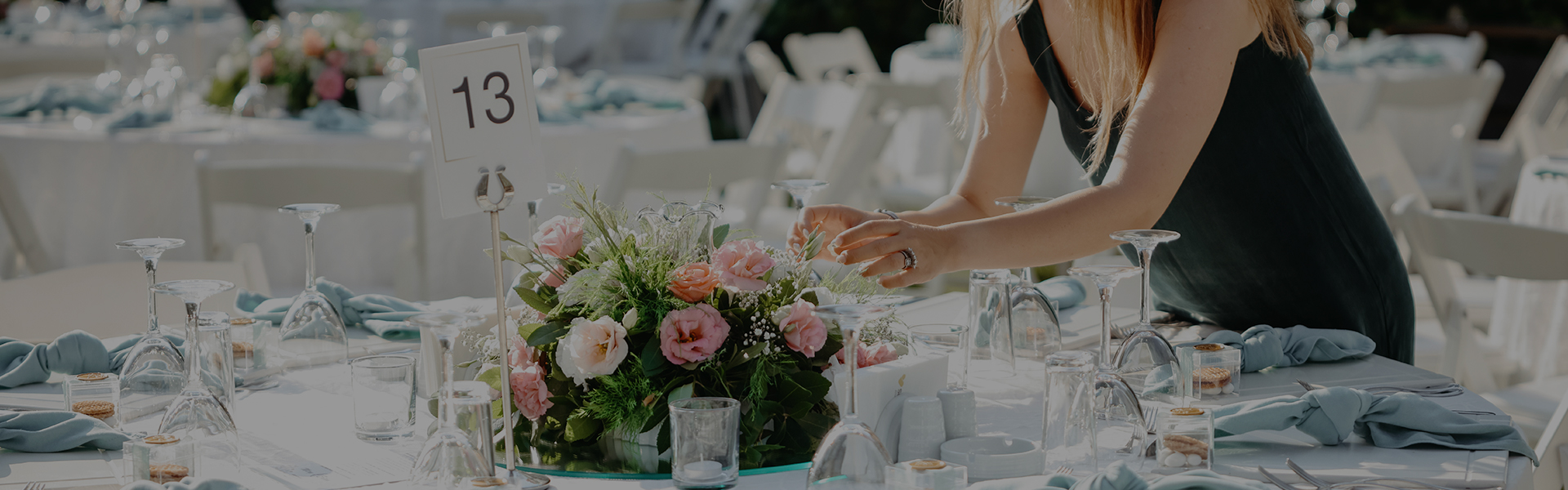 a woman arranging flowers on a table