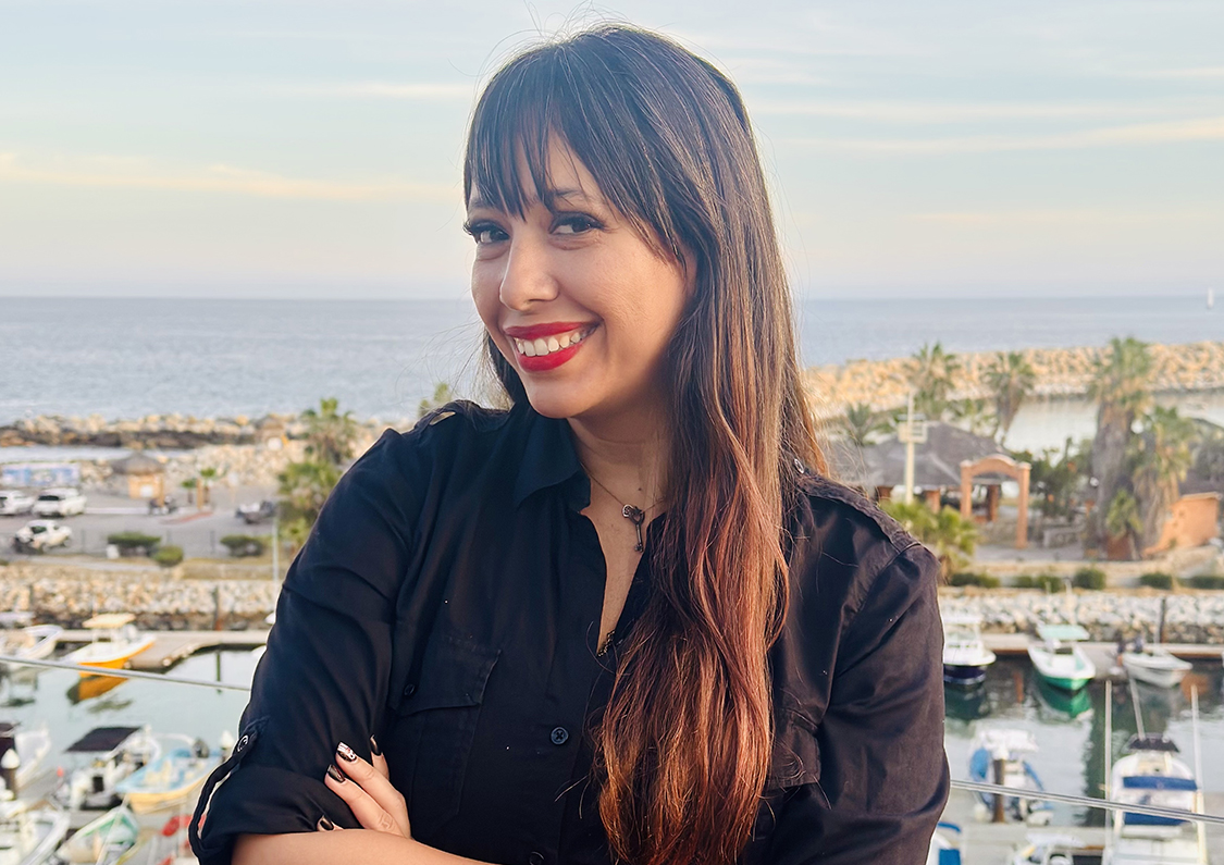 a woman smiling with her arms crossed
