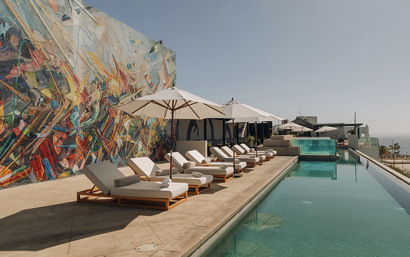a pool with umbrellas and lounge chairs