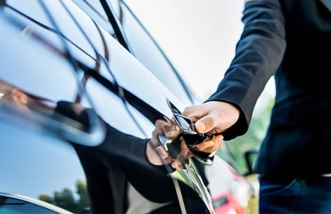 a person opening a car door