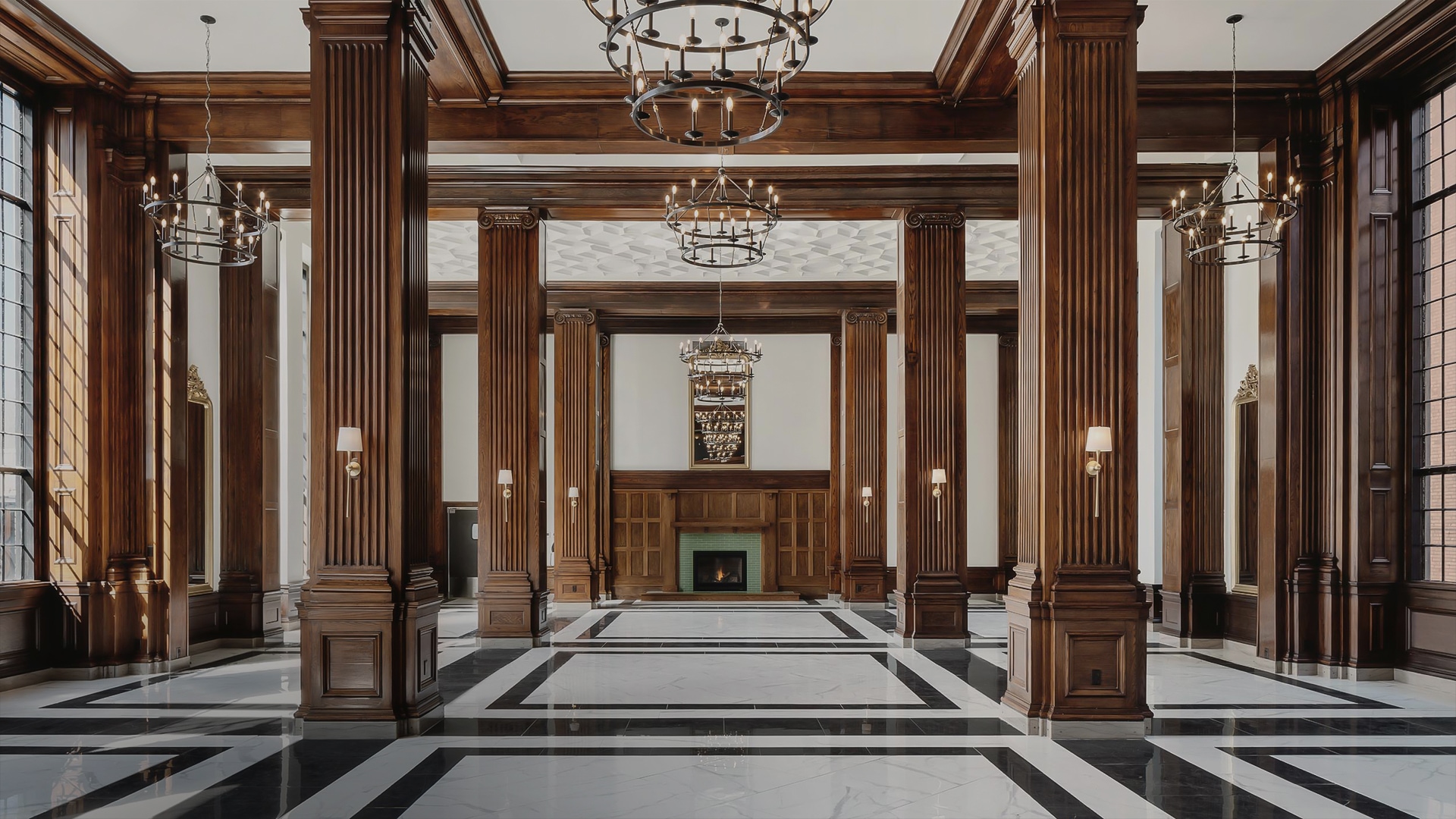 a large room with columns and chandeliers