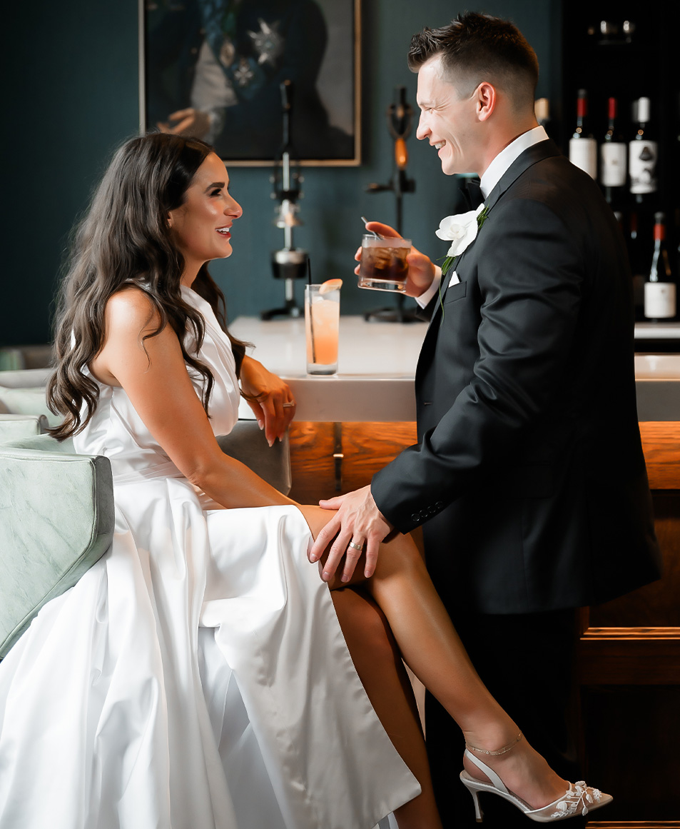a man and woman sitting at a bar
