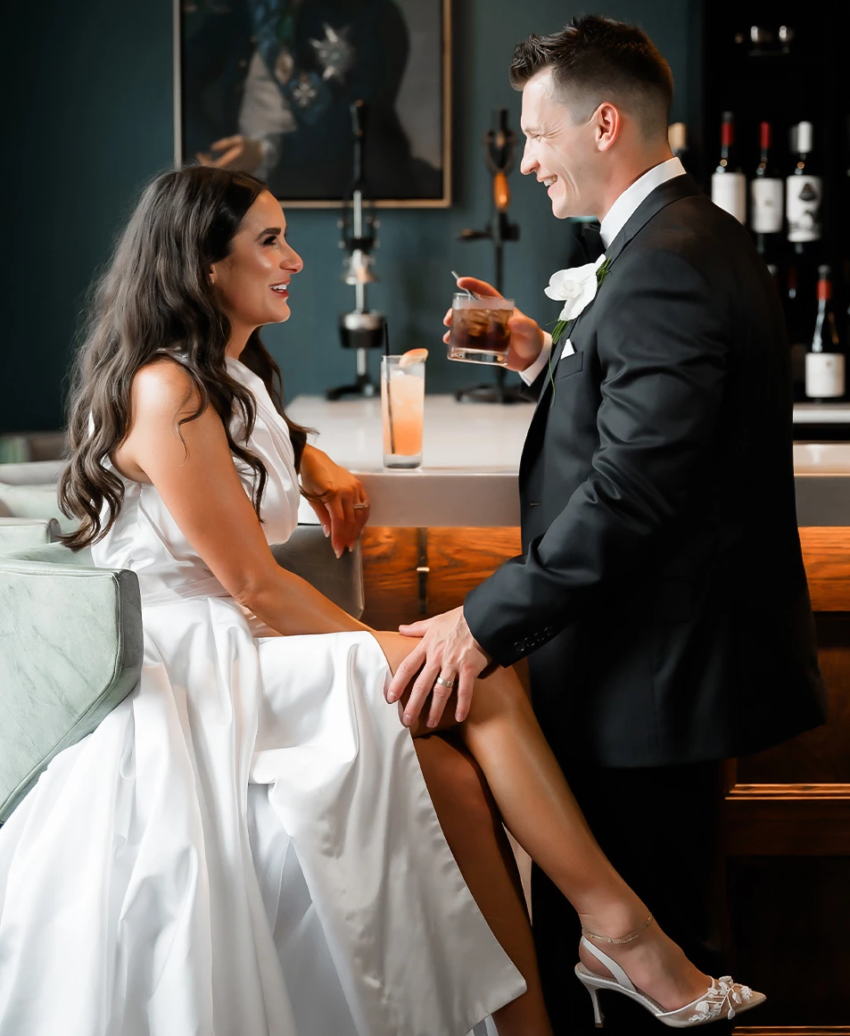a man and woman sitting at a bar