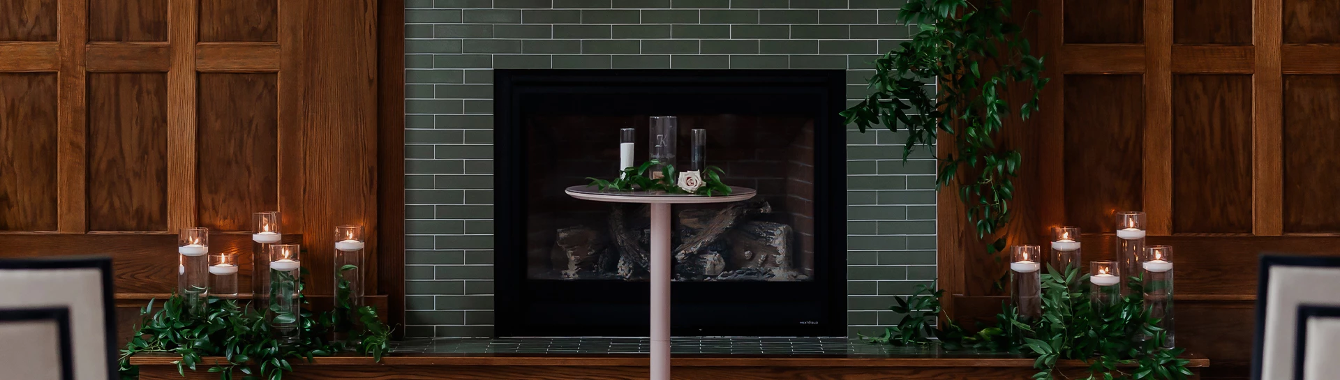 a table with vases on it and a white rose on it