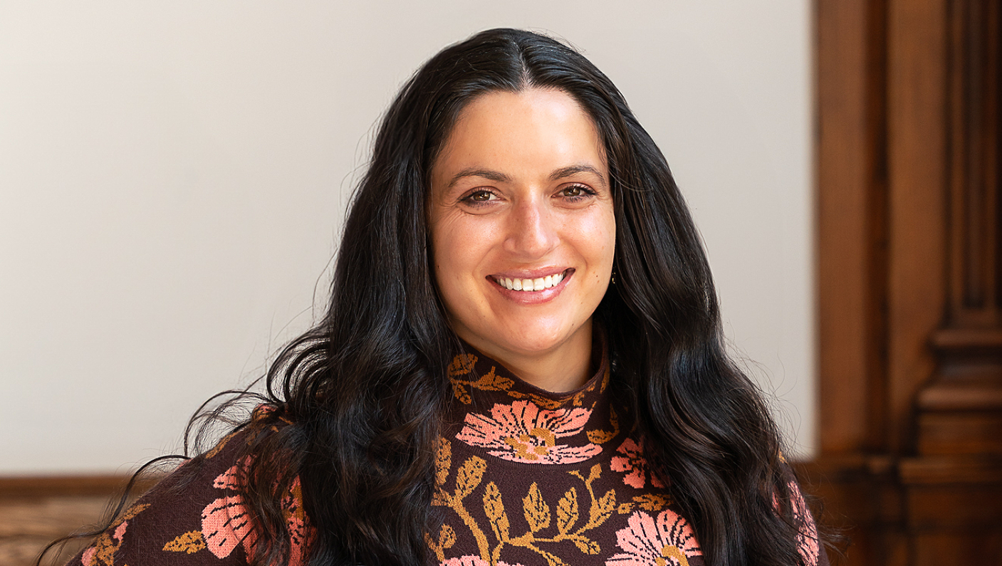 a woman with long black hair smiling