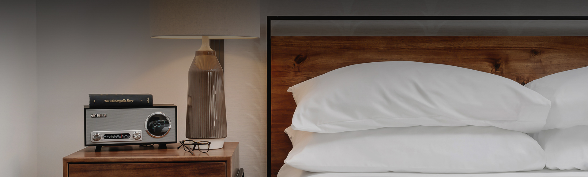 a lamp next to a bed