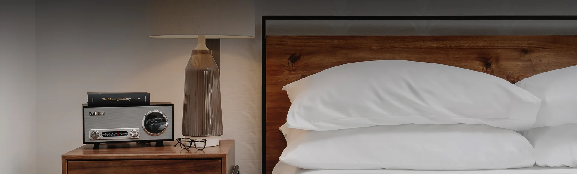 a lamp next to a bed