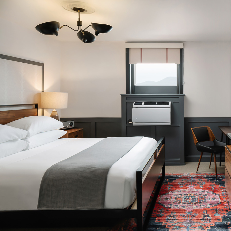 a room with a bed and a desk