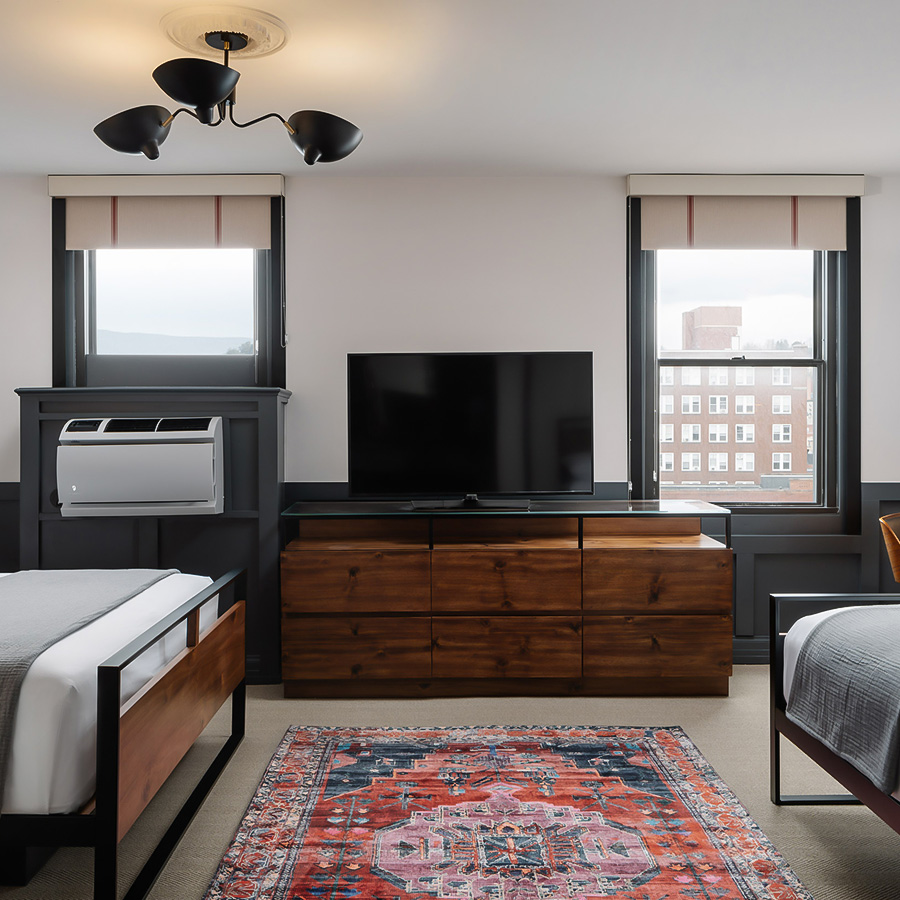 a room with two beds and a tv