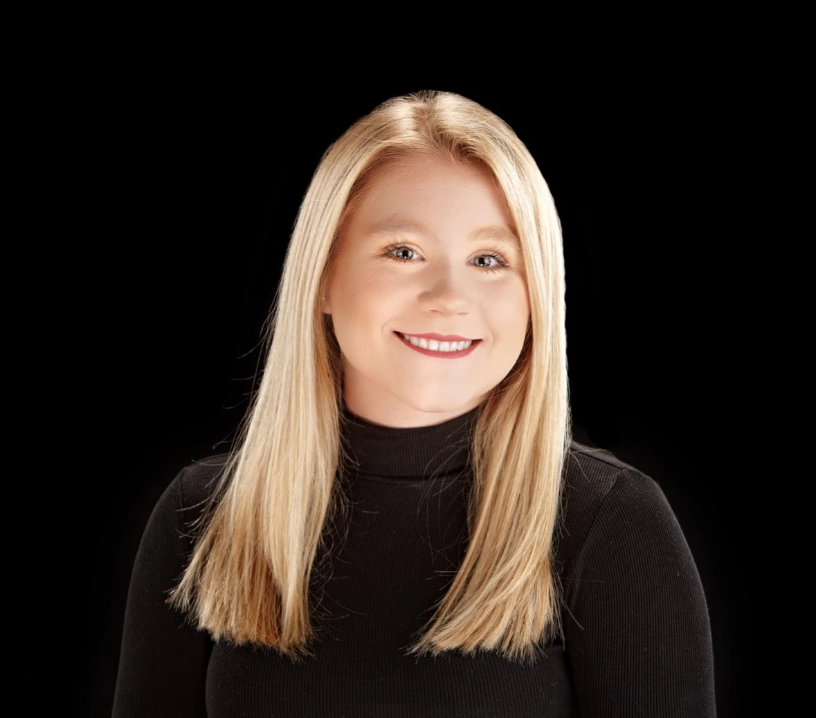 a woman with blonde hair wearing a black turtleneck