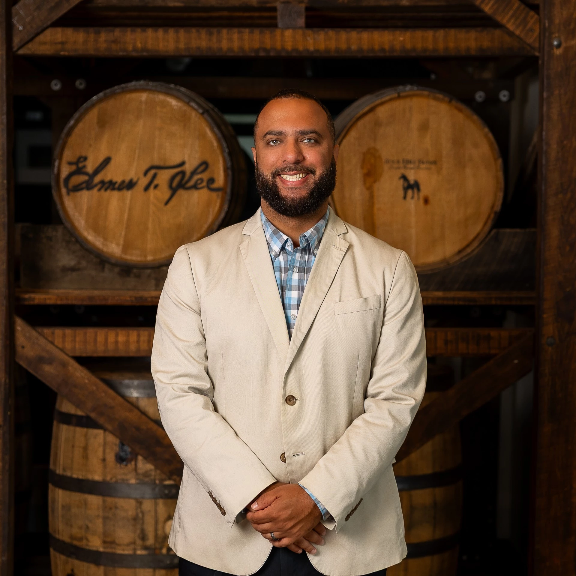 a man standing in front of barrels