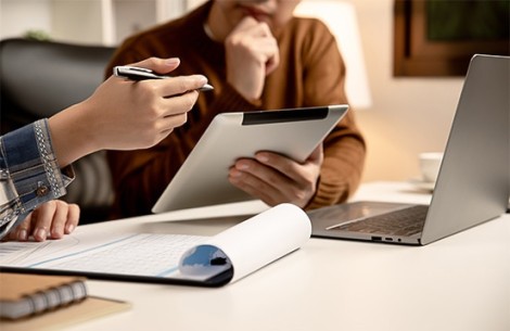 a person holding a tablet and pen
