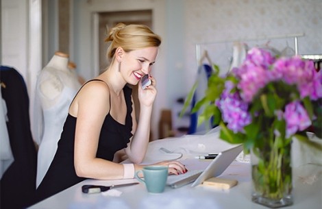 a woman sitting at a desk talking on the phone
