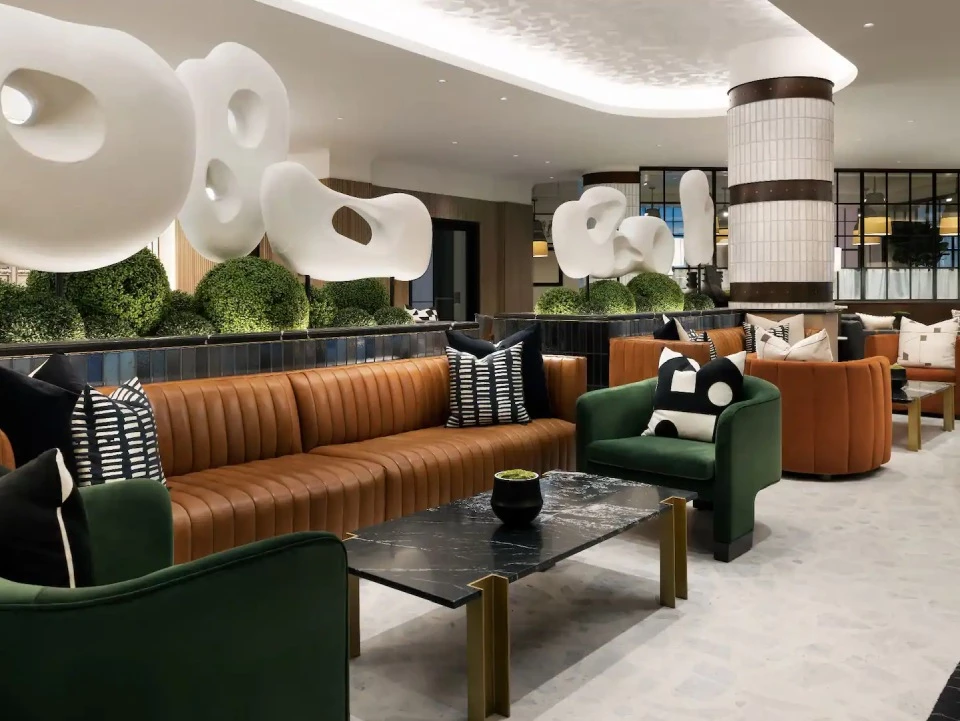 a room with a couch and chairs