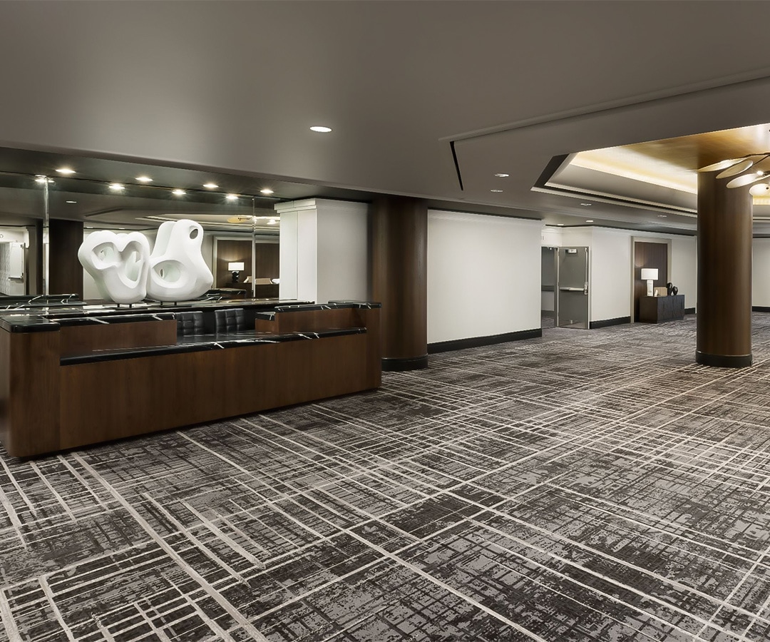 a large room with a reception desk and a mirror