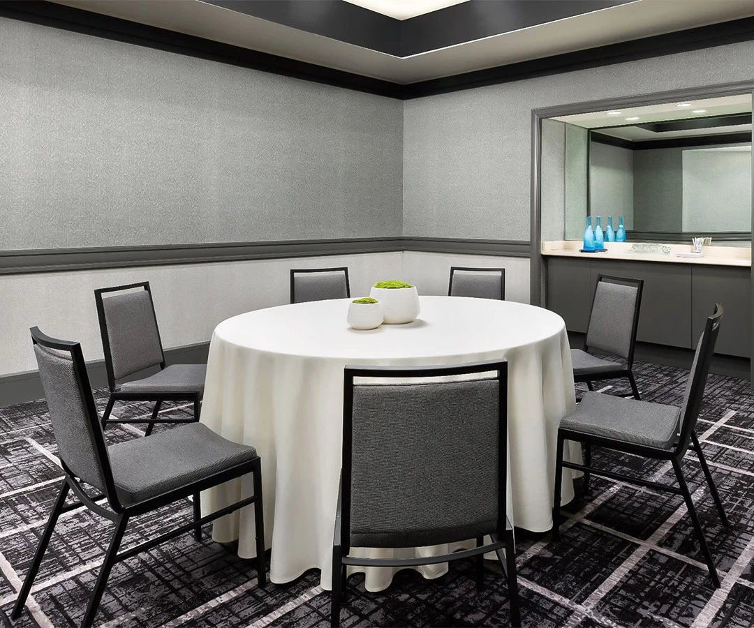 a room with a round table and chairs