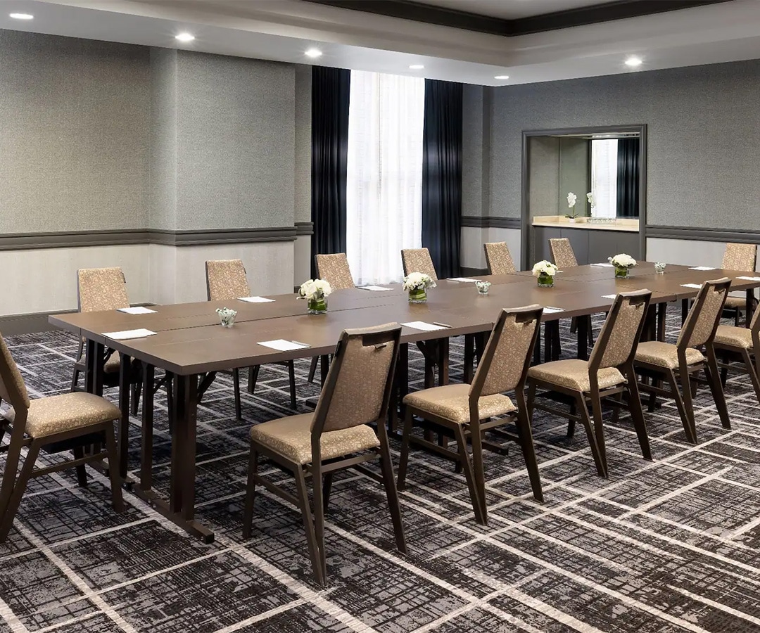 a room with a long table and chairs