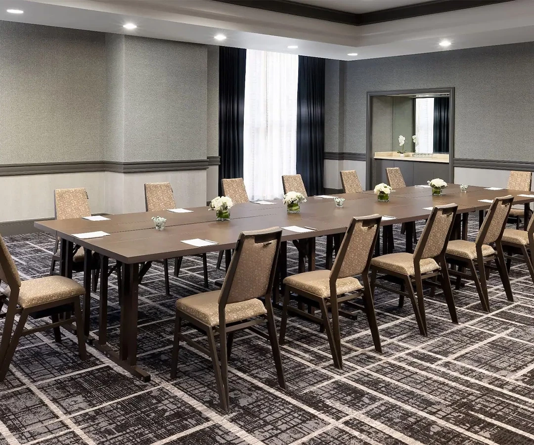 a room with a long table and chairs