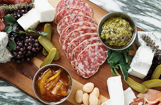 a wooden board with food on it