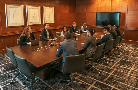 a group of people sitting around a table