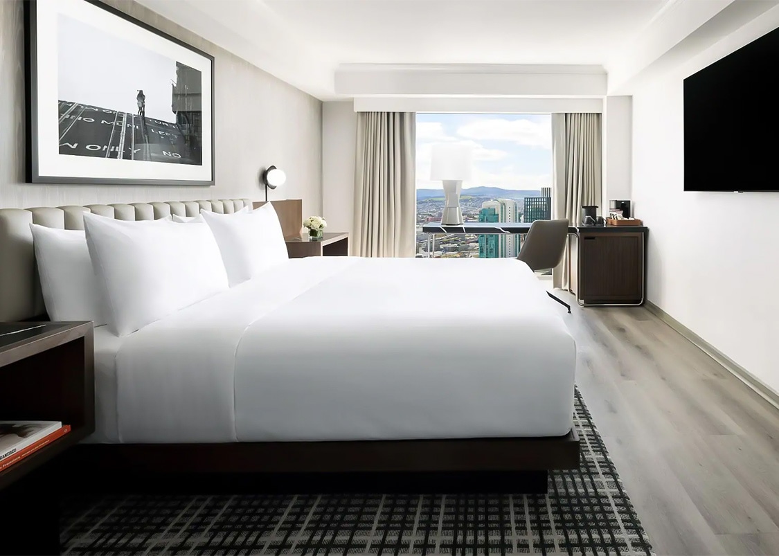 a hotel room with a large bed and a window
