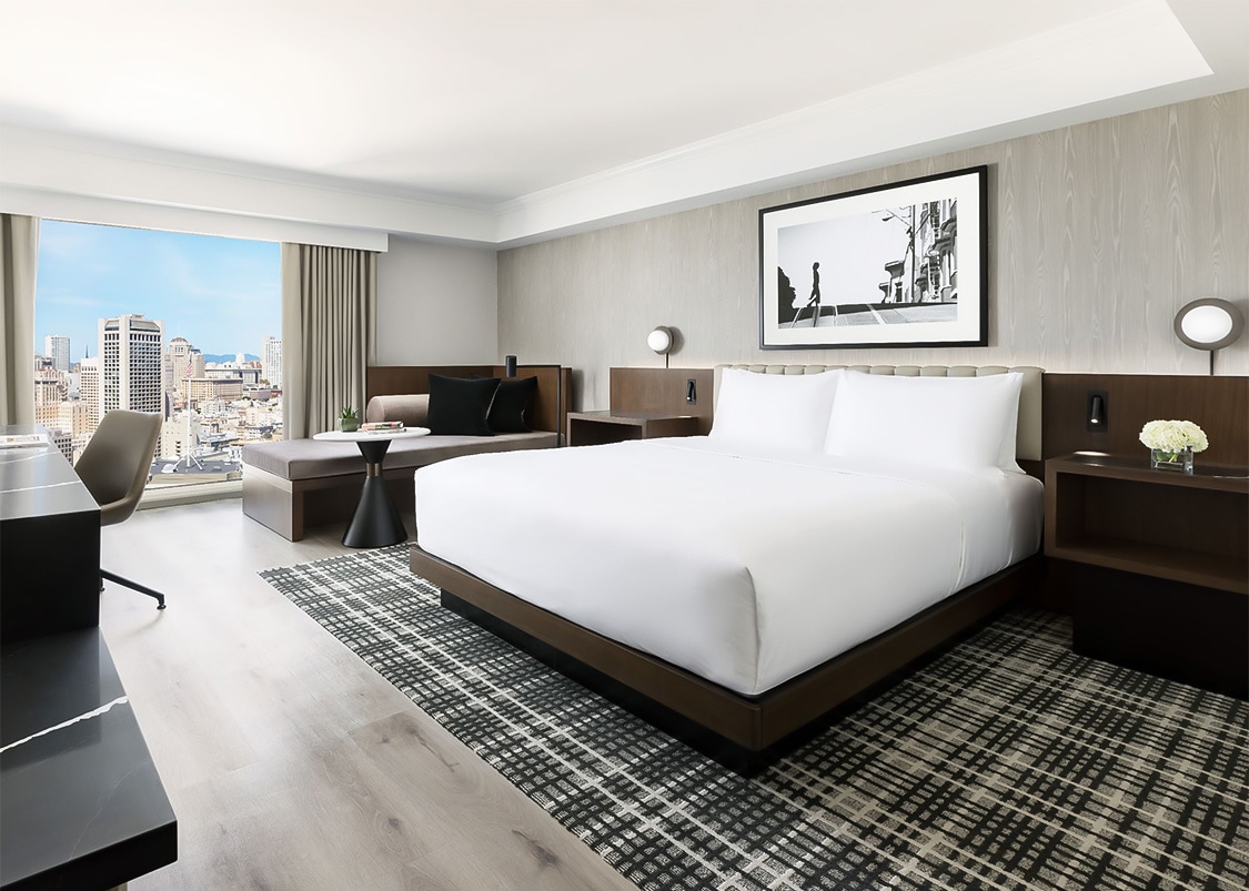 a bedroom with a large bed and a window