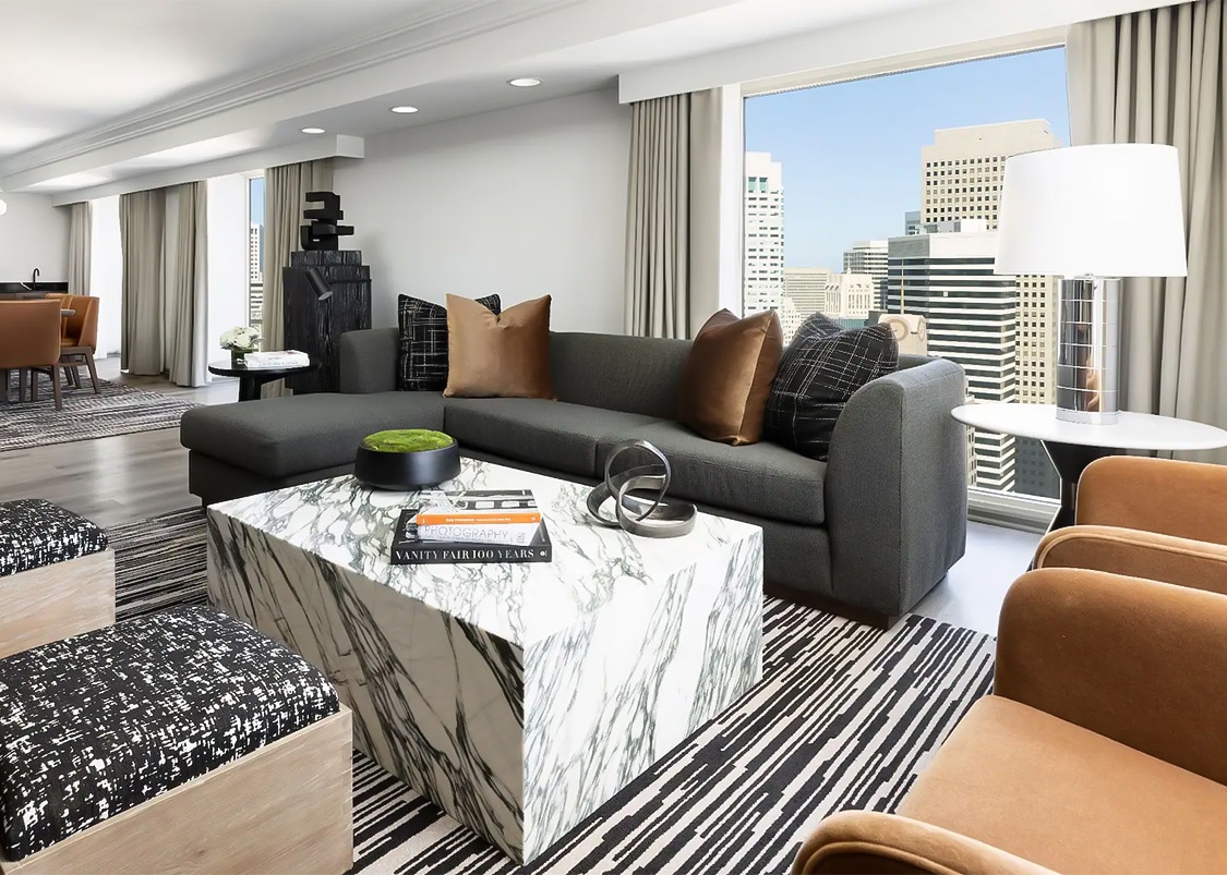 a living room with a marble coffee table and couches