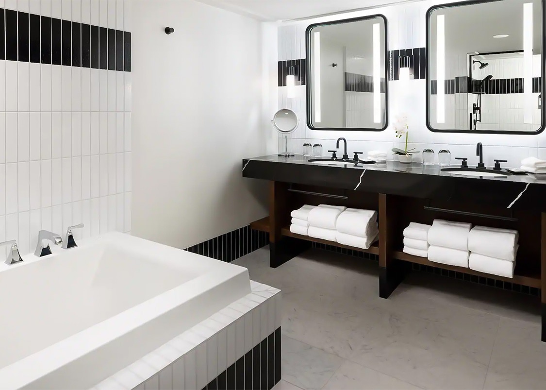 a bathroom with a tub and sinks