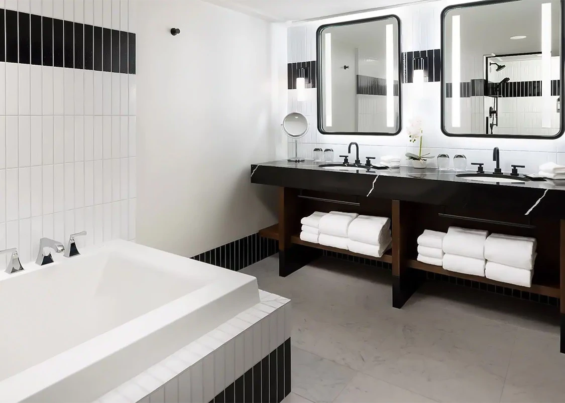 a bathroom with a tub and sinks
