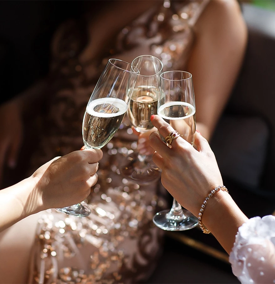 a group of women holding champagne glasses