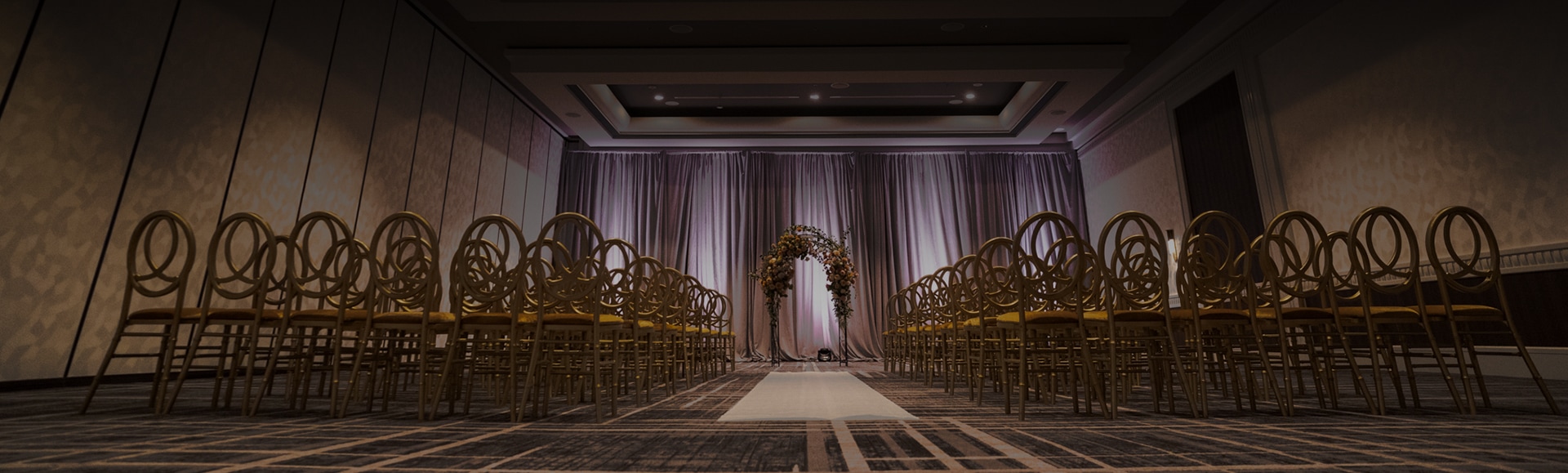 a wedding ceremony with chairs and a arch