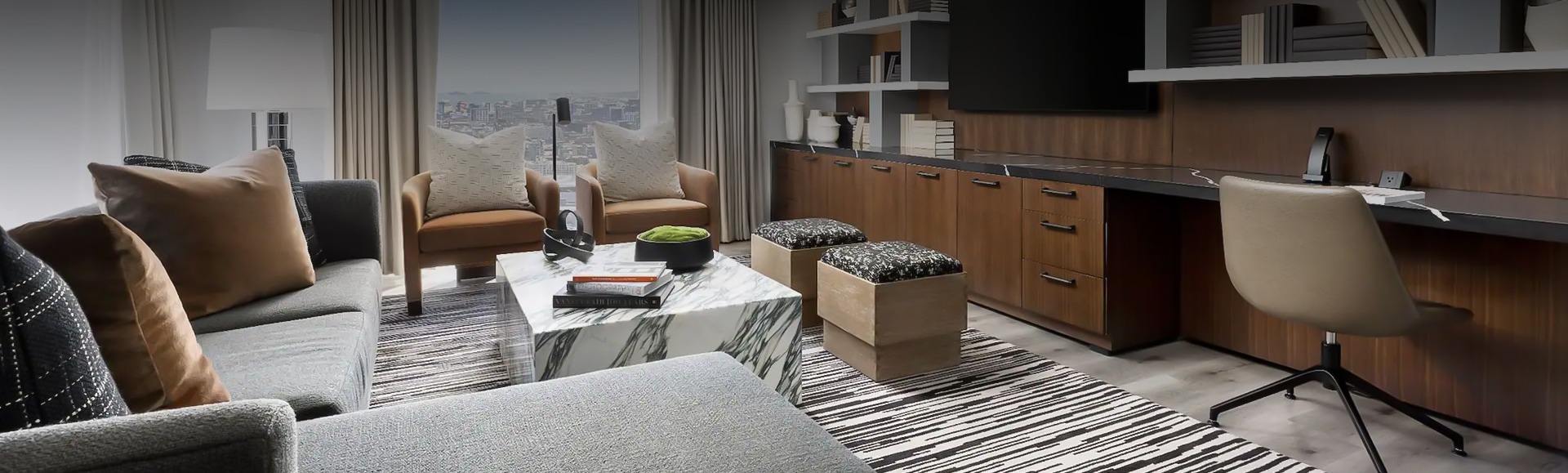 a living room with a marble coffee table and chairs