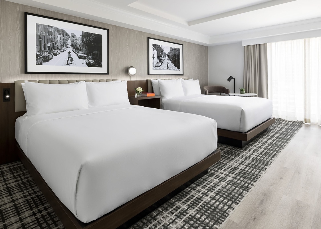 a room with two beds and a picture on the wall