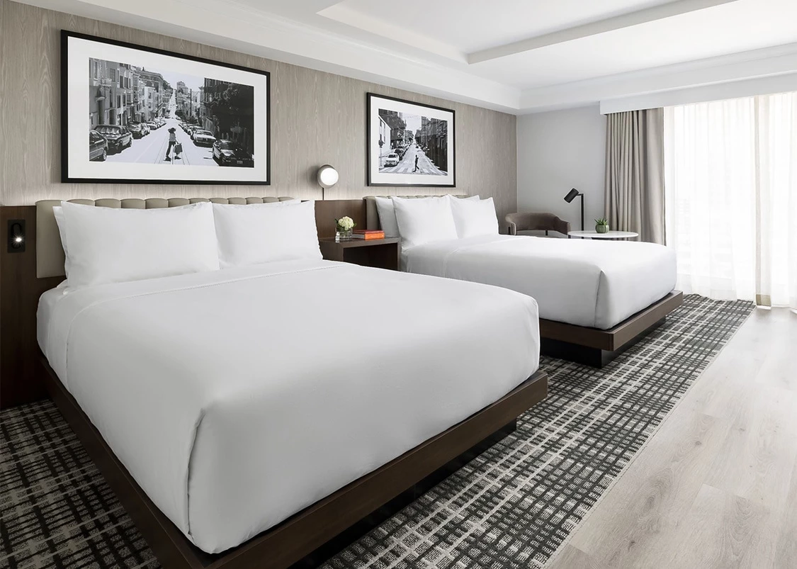 a room with two beds and a picture on the wall