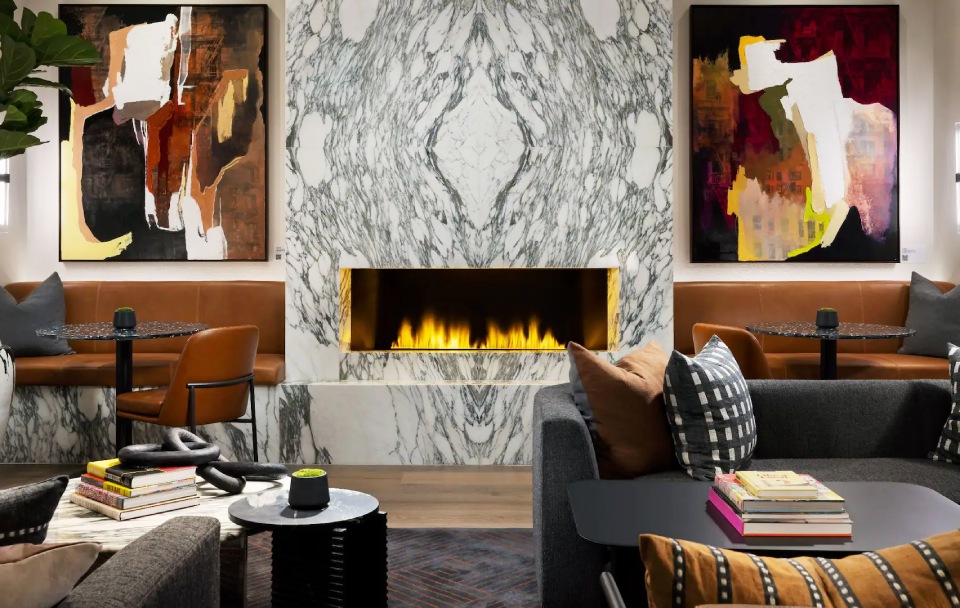 a fireplace in a room with art on the wall