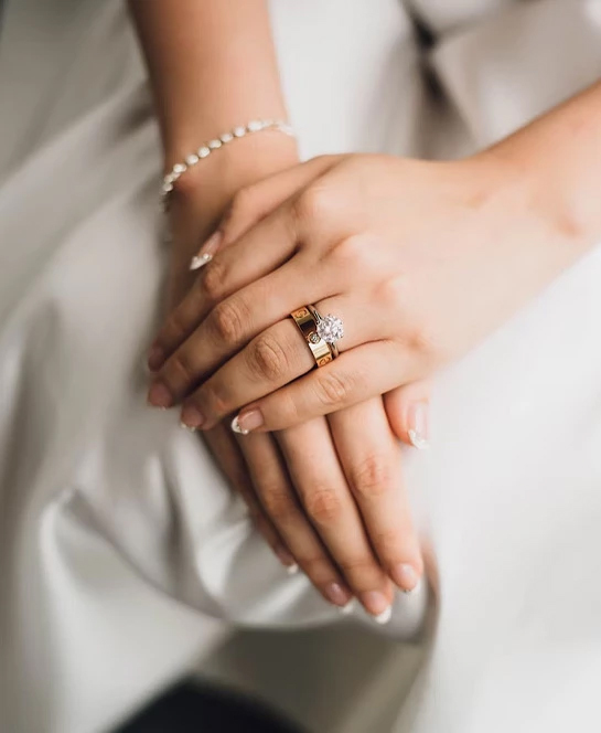 a close up of hands with a ring on