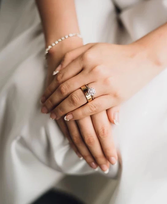 a close up of hands with a ring on