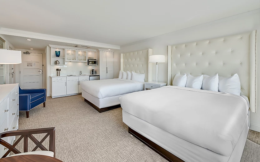 a room with two beds and a kitchen