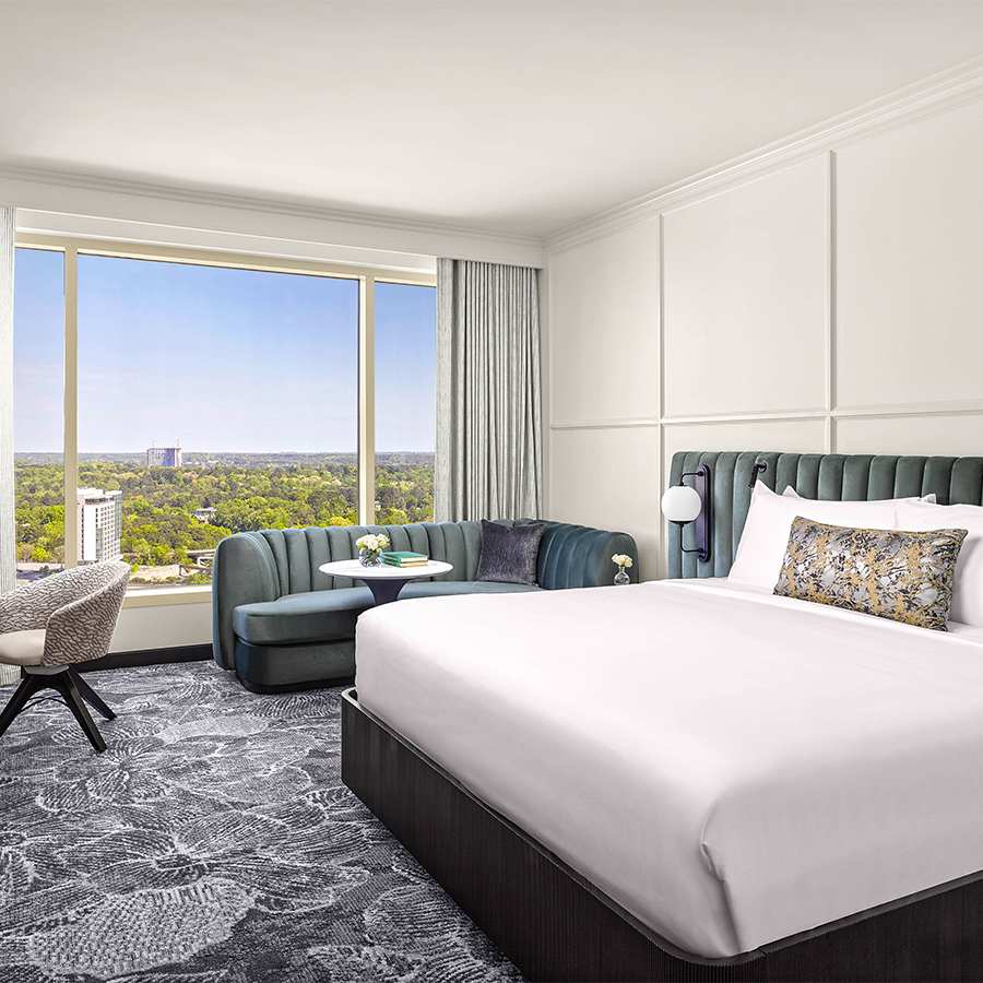 a room with a bed and a chair and a table