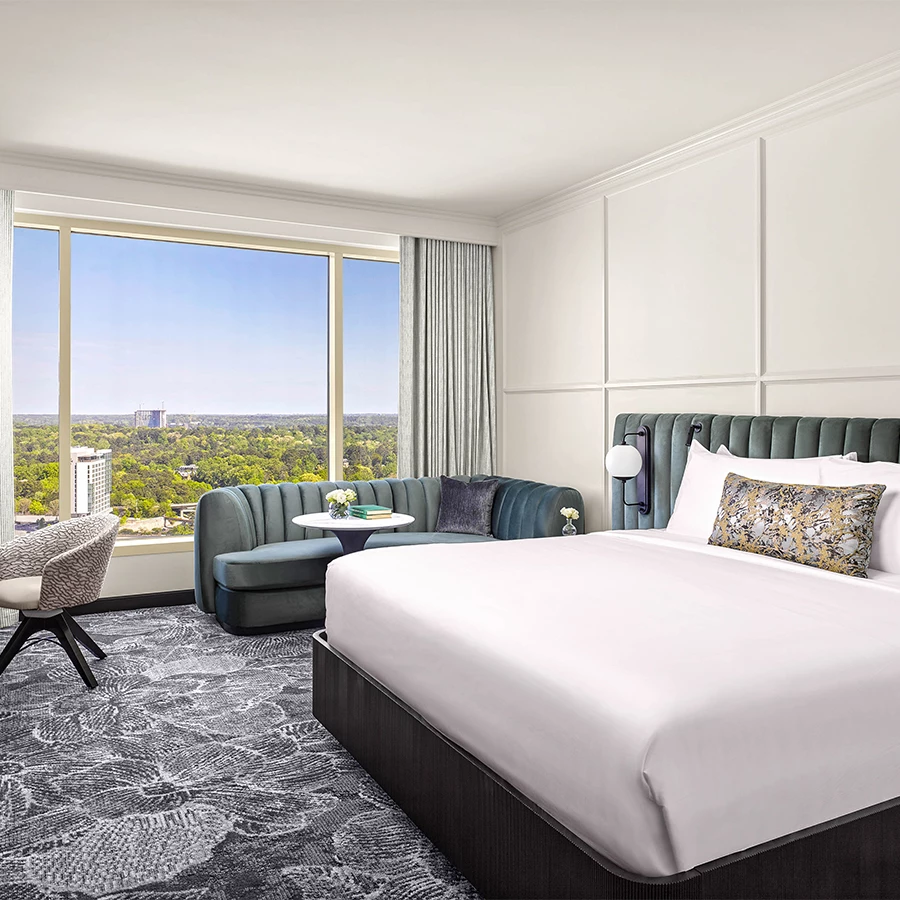 a room with a bed and a chair and a table