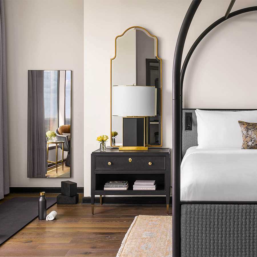 a mirror next to a bed