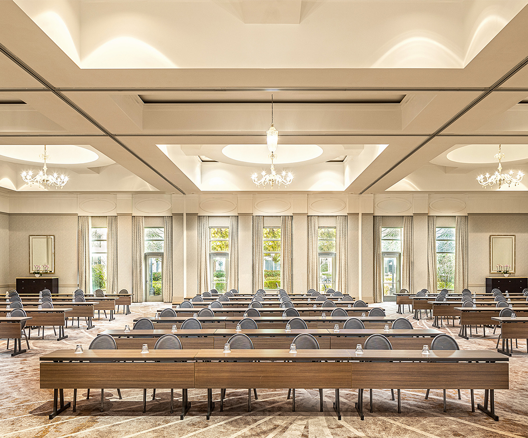 a room with long tables and chairs