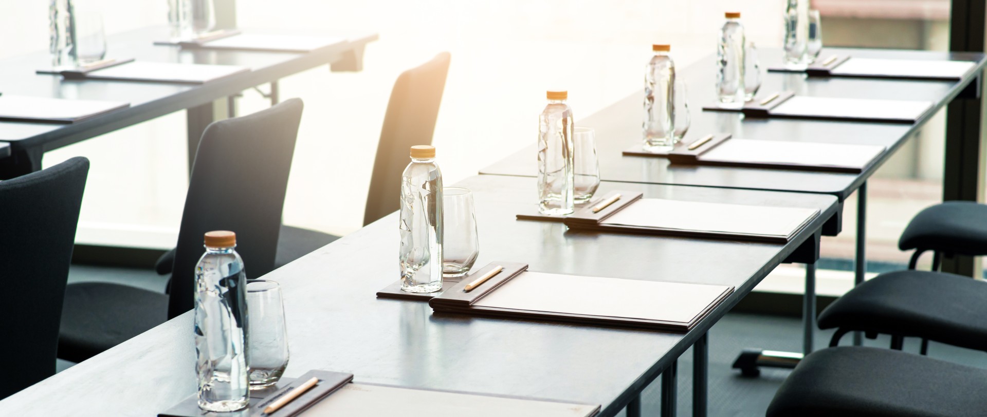 a table with empty glasses and bottles on it