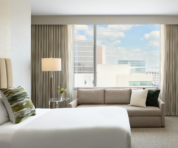 a hotel room with a couch and a bed